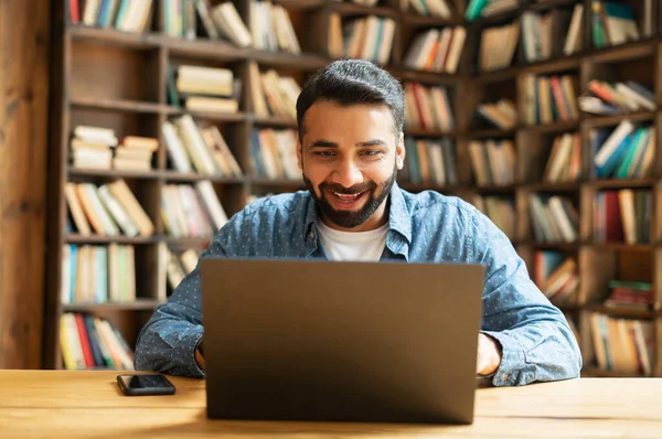 Förvånad positiv leende indisk frilansare kille med bärbar dator — Stockfoto