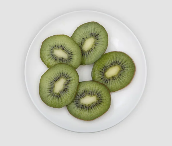 Sliced kiwi on a white plate — Stock Photo, Image