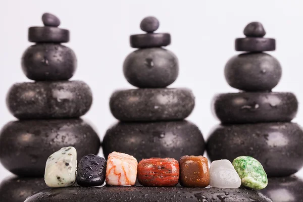 Row Of Chakra Crystals on hot massage stones — Stock Photo, Image