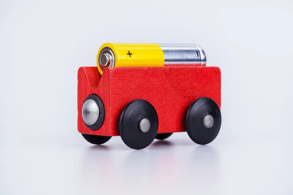 AA alkaline battery on a wood wagon — Stock Photo, Image