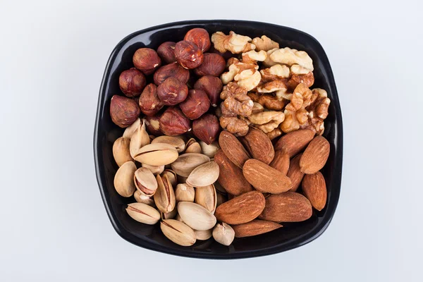 Assorted nuts in ceramic bowl — Stock Photo, Image