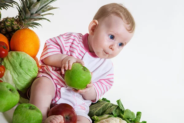 Cute baby sitting with fruits and vegetables — Stock Photo, Image