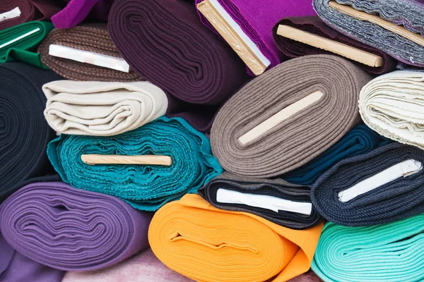 Rolls of fabric and textiles in a factory shop — Stock Photo, Image