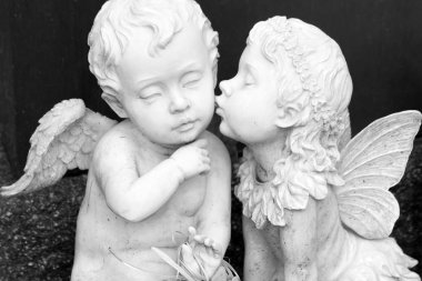 Kissing couple of angelic figurines clipart