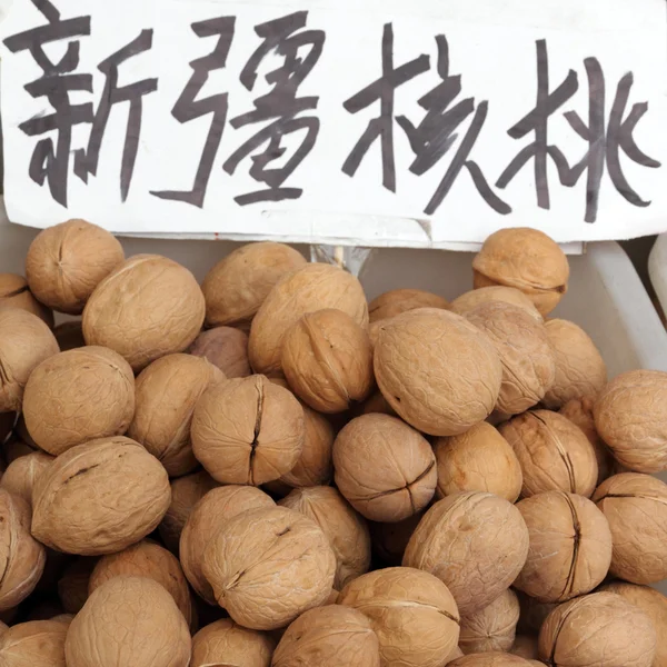 Walnuts on chinese market — Stock Photo, Image