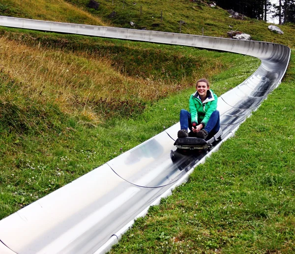 Girl on the summer toboggan run Royalty Free Stock Photos