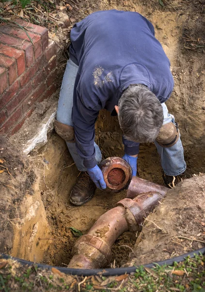 Hombre trabajando en tuberías de línea de alcantarillado de cerámica de arcilla vieja —  Fotos de Stock