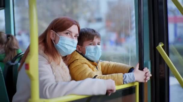 Femme avec un enfant portant des masques médicaux suit les précautions modernes pour protéger contre le virus et l'infection dans la société — Video