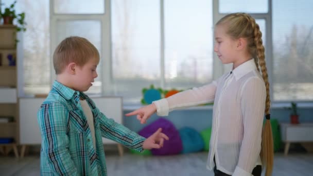 Syskon relation, flicka lär pojke med funktionshinder att visa jag älskar dig symbol och sedan krama varandra — Stockvideo