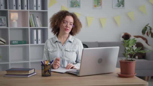 Distance education, young female student is undergoing training online using modern technologies video communication on laptop — Stock video