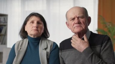 modern medicine, elderly married couple feeling unwell consult doctor online via video link laptop, look at camera