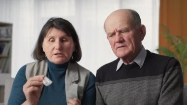 distance medicine, old women and men feeling unwell consult doctor online with help of modern technologies via video link laptop, look at camera