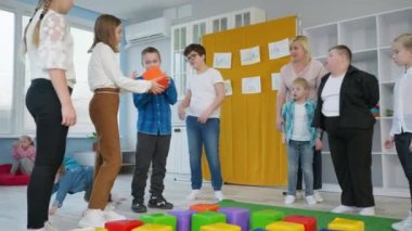 Engelli çocuklar okulu, neşeli çocuklar kapsayıcı bir sınıfta gelişim eğitiminde eğleniyor.