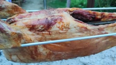cook food in nature, food festival, grilled whole carcass of ram on a fire at summer day