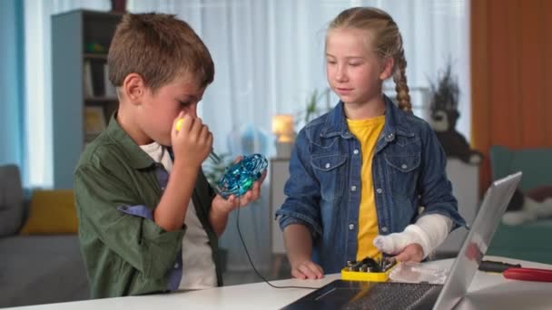 Děti a technologie, bratr a sestra s nástroji připojenými mini quadcopter k notebooku doma — Stock video