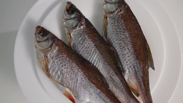 Морепродукты, жирная вкусная рыба на тарелке, вращающаяся на белом фоне — стоковое видео