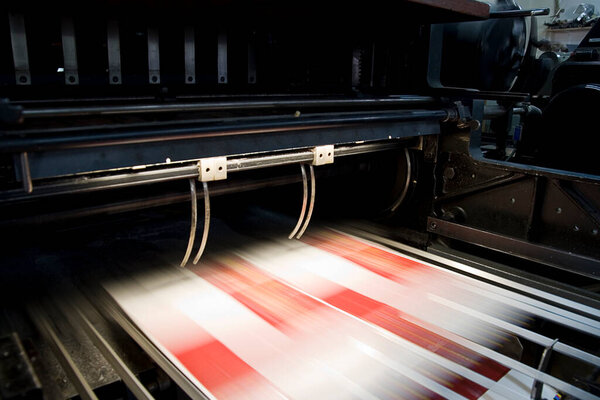 Paper die cutting machine press in motion