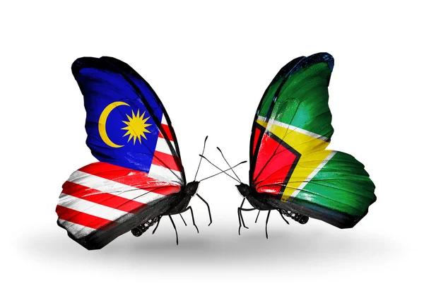 Borboletas com bandeiras da Malásia e da Guiana em asas — Fotografia de Stock