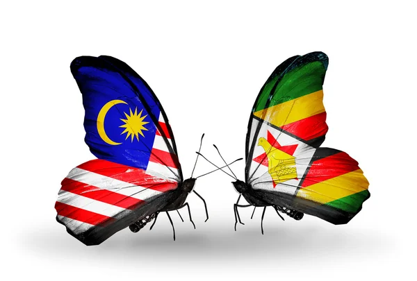 Butterflies with Malaysia and Zimbabwe flags on wings — Stock Photo, Image