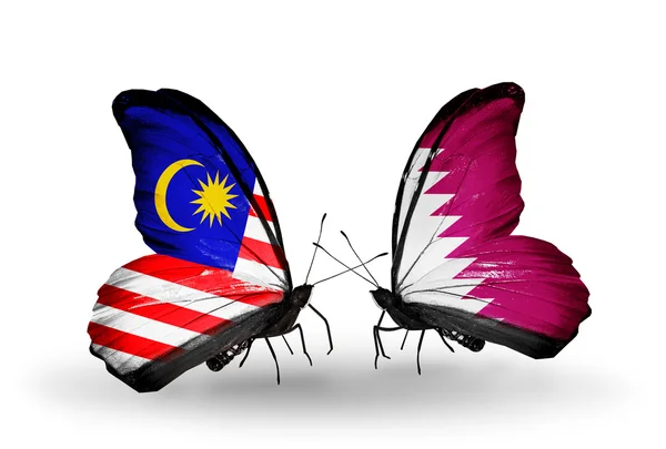 Butterflies with Malaysia and Qatar flags on wings — Stock Photo, Image