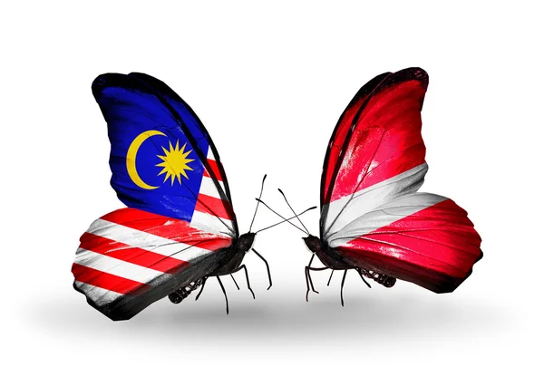 Butterflies with Malaysia and Latvia flags on wings — Stock Photo, Image