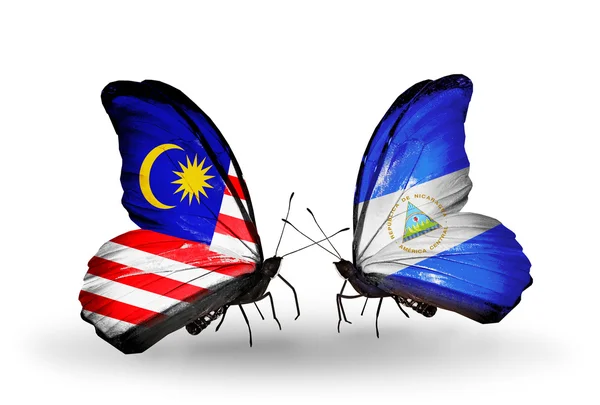 Borboletas com bandeiras da Malásia e Nicarágua em asas — Fotografia de Stock