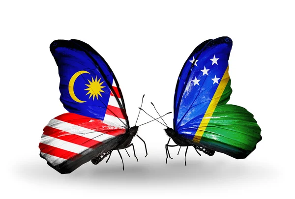 Farfalle con bandiere Malesia e Isole Salomone sulle ali — Foto Stock