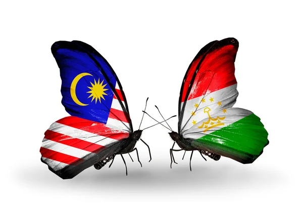 Farfalle con bandiere Malesia e Tagikistan sulle ali — Foto Stock