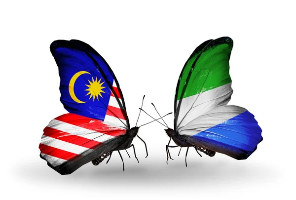 Borboletas com bandeiras da Malásia e Serra Leoa em asas — Fotografia de Stock