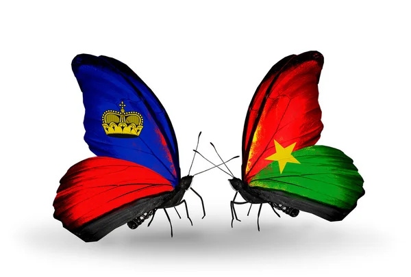 Mariposas con banderas de Liechtenstein y Burkina Faso en alas — Foto de Stock