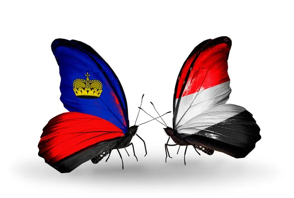 Schmetterlinge mit Liechtenstein und Jemen-Flaggen auf Flügeln — Stockfoto