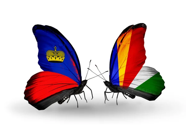 Borboletas com bandeiras de Liechtenstein e Seychelles em asas — Fotografia de Stock