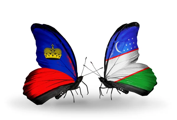 Schmetterlinge mit Liechtenstein und Usbekistan-Flaggen auf Flügeln — Stockfoto