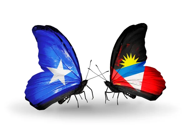 Butterflies with Somalia and Antigua and Barbuda flags — Stock Photo, Image