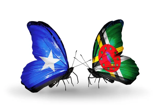 Vlinders met Somalië en Dominica vlaggen — Stockfoto