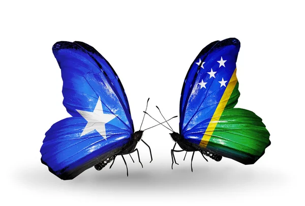 Farfalle con bandiere Somalia e Isole Salomone sulle ali — Foto Stock