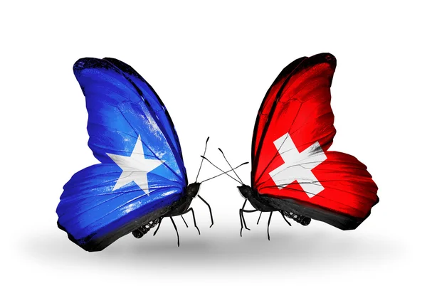 Butterflies with Somalia and  Switzerland flags — Stock Photo, Image