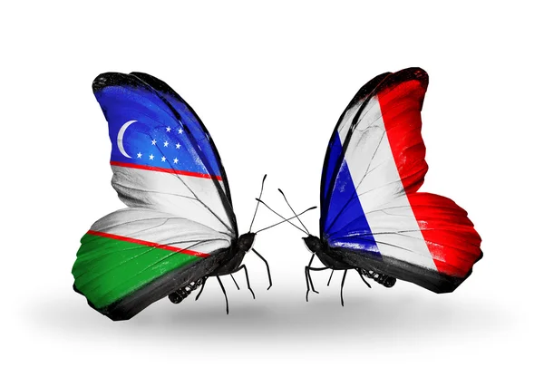 Butterflies with Uzbekistan and France flags — Stock Photo, Image