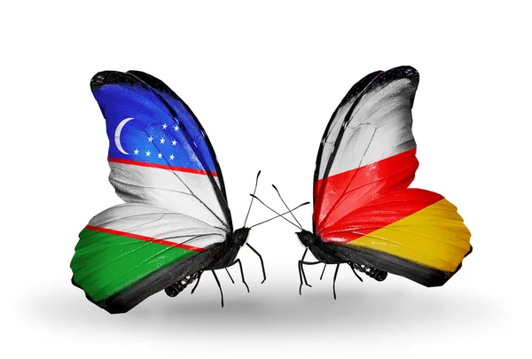 Farfalle con bandiere Uzbekistan e Ossezia del Sud — Foto Stock