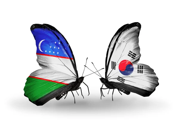 Vlinders met Oezbekistan en Zuid-Korea vlaggen — Stockfoto