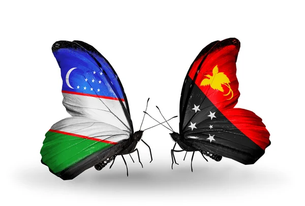Πεταλούδες με σημαίες του Ουζμπεκιστάν και της Παπούα Νέας Γουινέας — Φωτογραφία Αρχείου