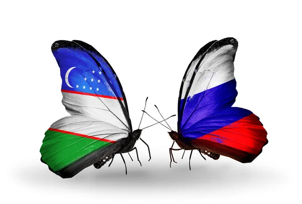 Butterflies with Uzbekistan and Russia flags — Stock Photo, Image