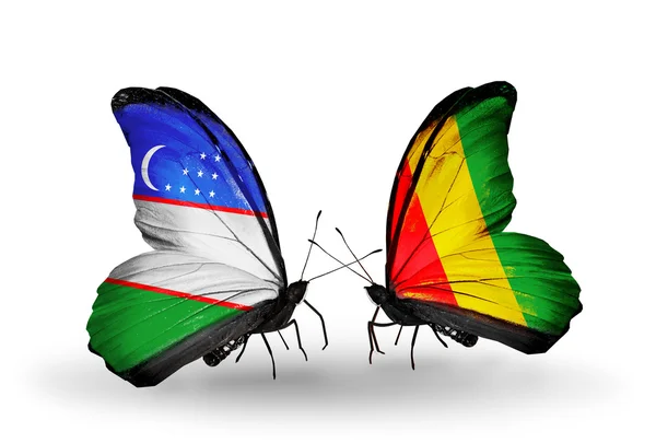 Butterflies with Uzbekistan and Guinea flags — Stock Photo, Image