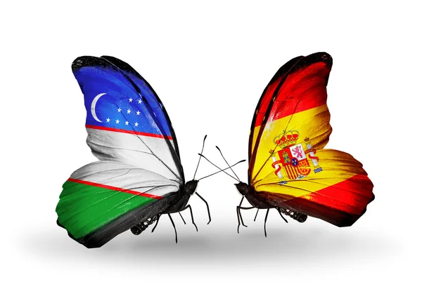 Butterflies with Uzbekistan and Spain flags — Stock Photo, Image