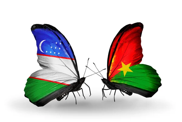 Mariposas con banderas de Uzbekistán y Burkina Faso — Foto de Stock