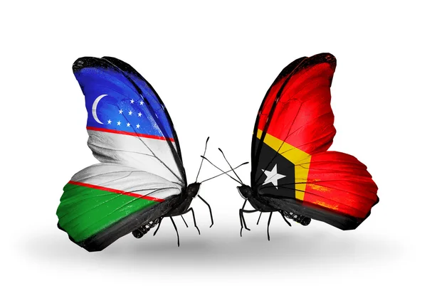 Butterflies with Uzbekistan and East Timor flags — Stock Photo, Image