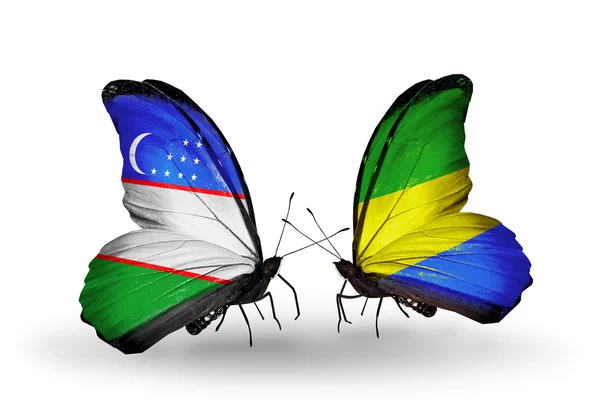 Butterflies with Uzbekistan and Gabon flags — Stock Photo, Image