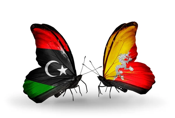 Fjärilar med Libyen och Bhutan flaggor — Stockfoto