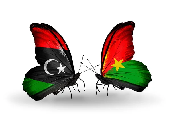 Бабочки с флагами Ливии и Буркина-Фасо — стоковое фото
