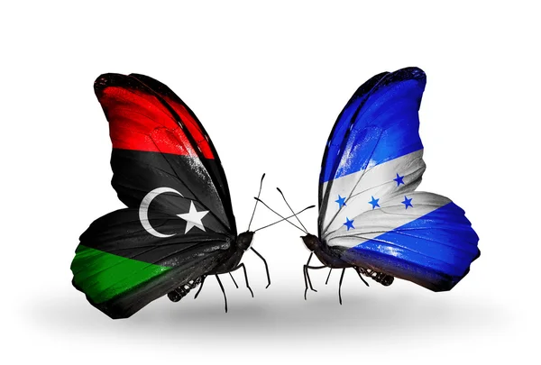 Schmetterlinge mit libyschen und honduranischen Flaggen — Stockfoto